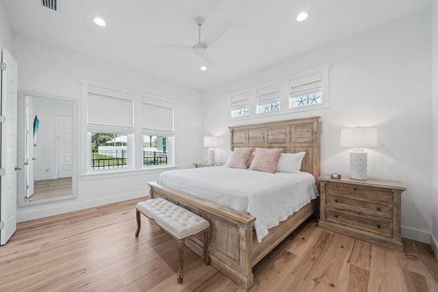 bedroom featuring multiple windows, light wood-style floors, baseboards, recessed lighting, and a ceiling fan
