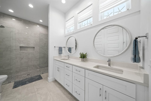 full bath with a walk in shower, double vanity, marble finish floors, recessed lighting, and toilet