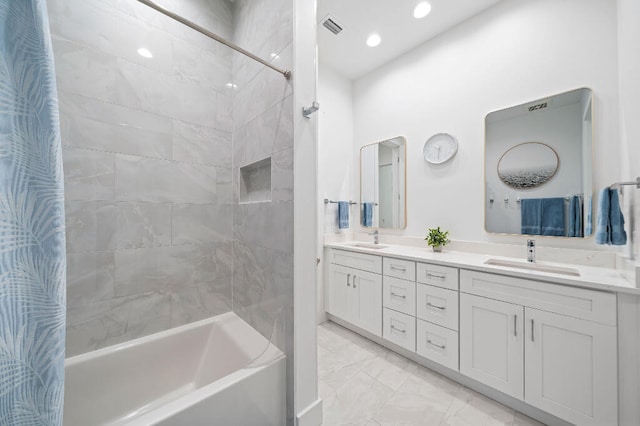 bathroom with marble finish flooring, shower / bath combo, double vanity, and recessed lighting