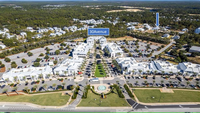 aerial view of property and surrounding area featuring a forest