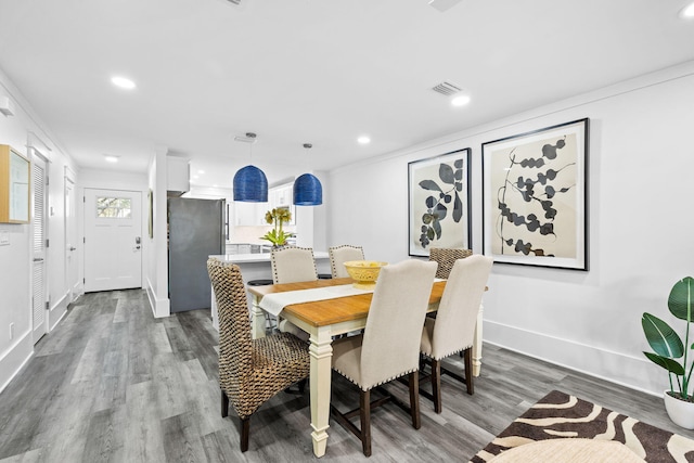 dining space with wood-type flooring