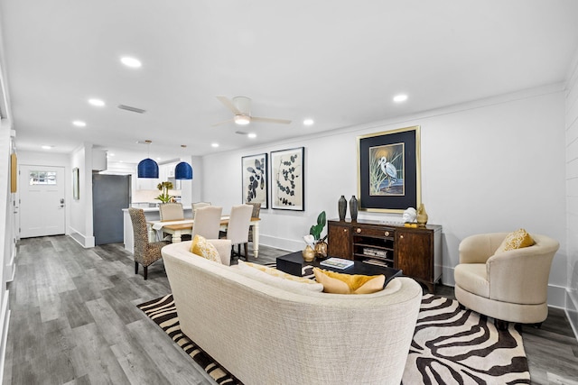 living room featuring ceiling fan and light wood-type flooring