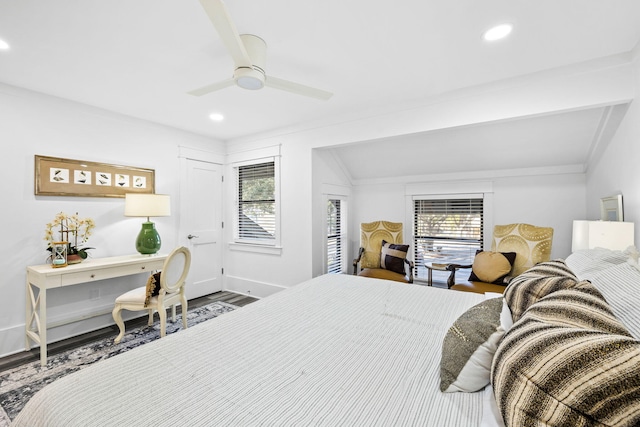 bedroom featuring ceiling fan, wood-type flooring, vaulted ceiling, and multiple windows