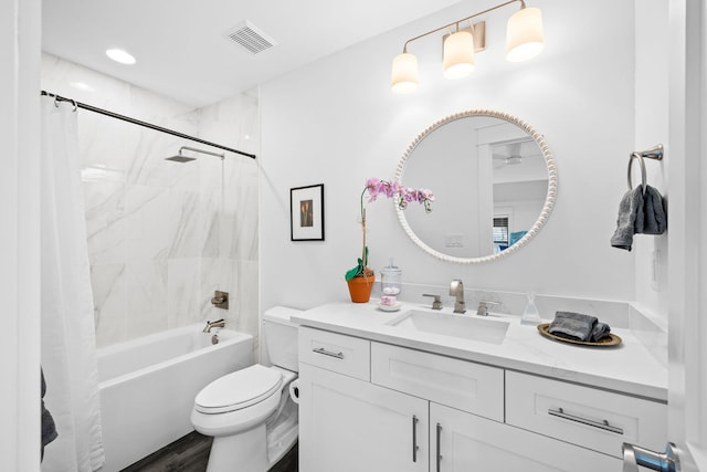 full bathroom with vanity, hardwood / wood-style floors, toilet, and shower / bath combo