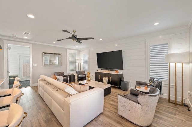 living room with ceiling fan, light hardwood / wood-style floors, and crown molding