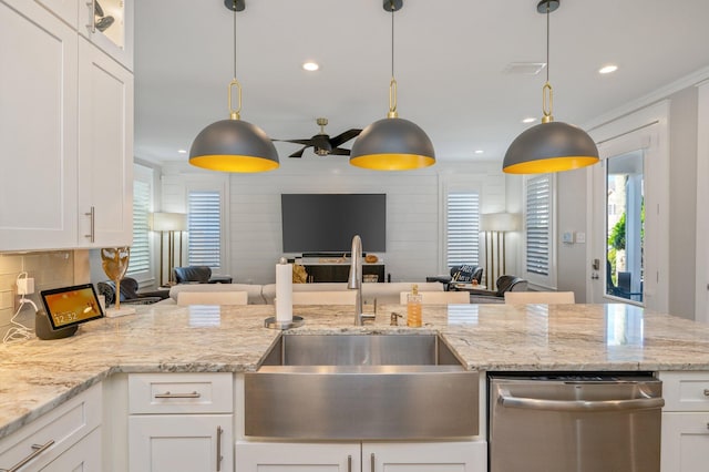 kitchen with dishwasher, sink, white cabinets, and decorative light fixtures