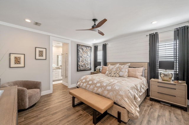 bedroom featuring ensuite bath, ceiling fan, dark hardwood / wood-style floors, and ornamental molding