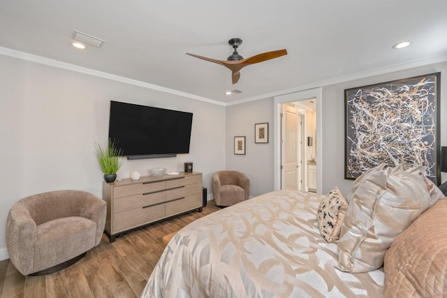 bedroom with connected bathroom, light hardwood / wood-style flooring, ceiling fan, and crown molding