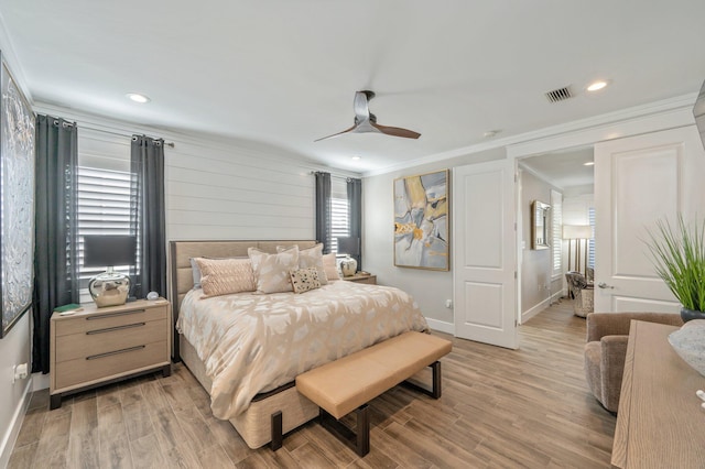 bedroom with ceiling fan, light hardwood / wood-style floors, and ornamental molding