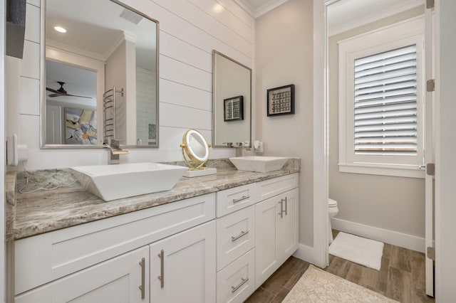 bathroom with ceiling fan, toilet, crown molding, and vanity