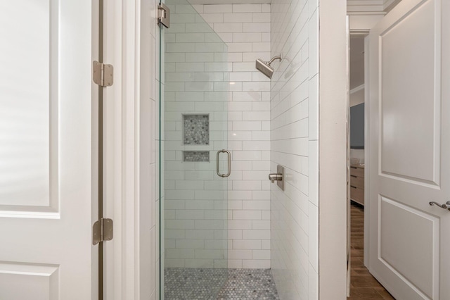 bathroom featuring hardwood / wood-style floors and a shower with door