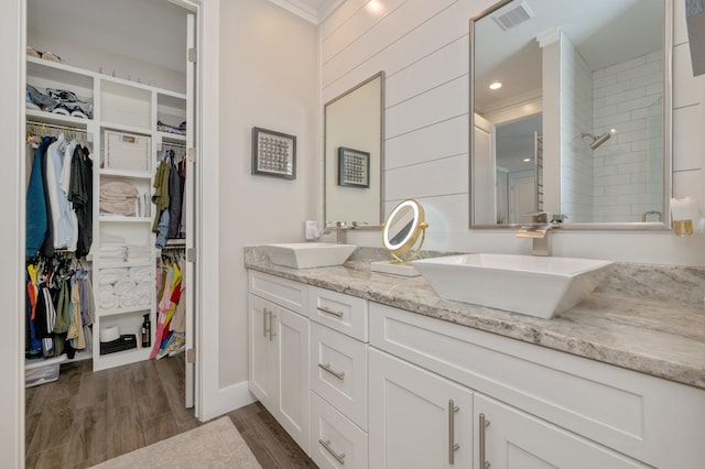 bathroom featuring a shower with door, vanity, ornamental molding, and hardwood / wood-style flooring