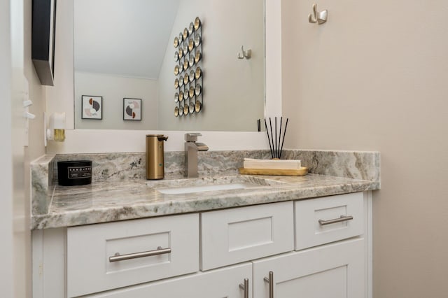 bathroom featuring vanity and vaulted ceiling