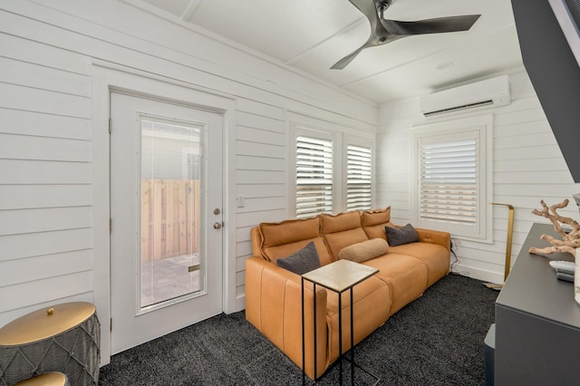 carpeted living room with a wall mounted AC and ceiling fan