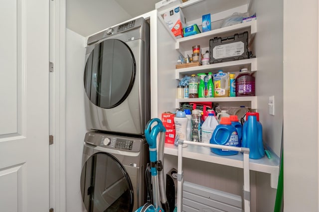 clothes washing area featuring stacked washer and clothes dryer