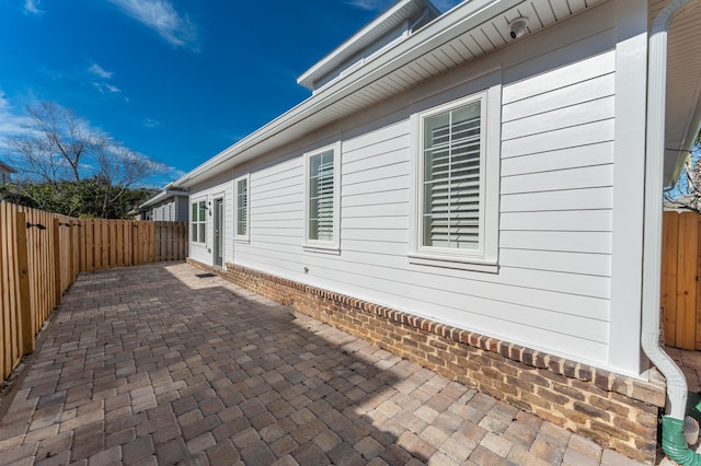 view of side of property featuring a patio area