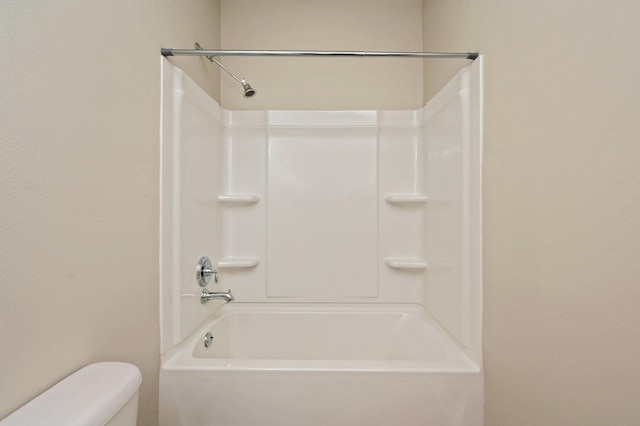 bathroom featuring bathing tub / shower combination and toilet