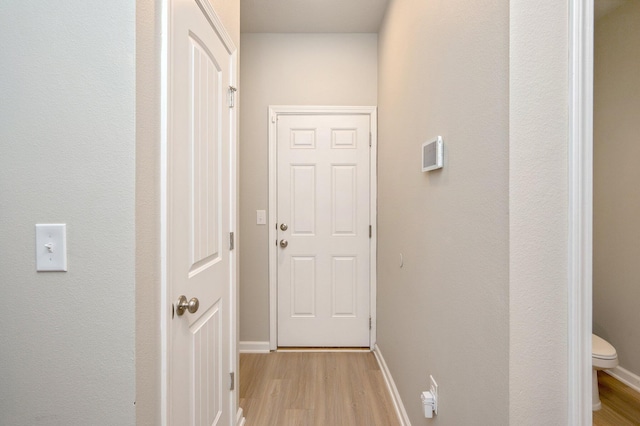 hallway with light hardwood / wood-style flooring