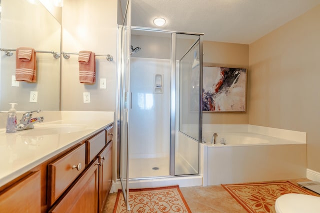 bathroom featuring tile patterned floors, vanity, and separate shower and tub