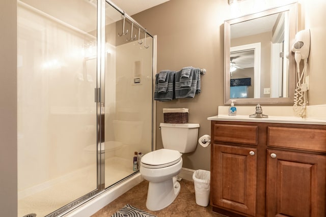 bathroom featuring walk in shower, vanity, tile patterned flooring, and toilet