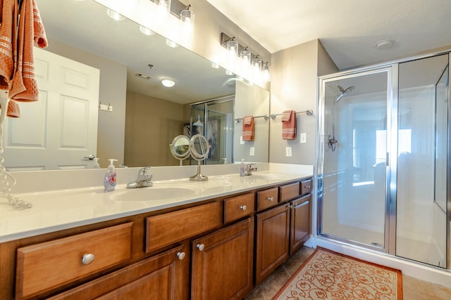 bathroom with vanity, tile patterned floors, and walk in shower