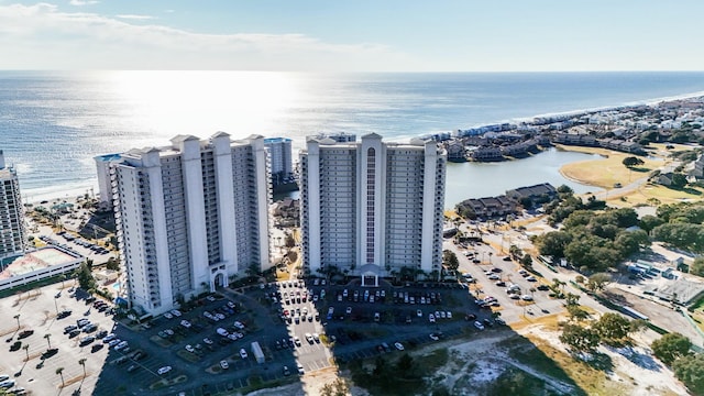 birds eye view of property with a water view and a view of the beach