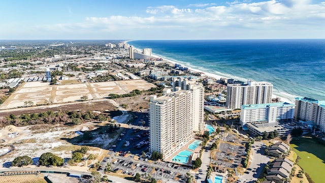 drone / aerial view featuring a water view and a beach view