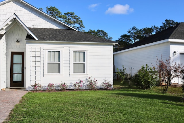 view of side of home with a lawn