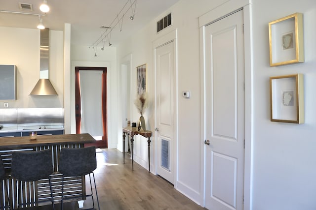 kitchen with wooden counters, hardwood / wood-style floors, and track lighting