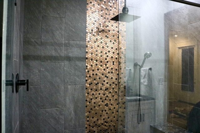 bathroom featuring a shower with door