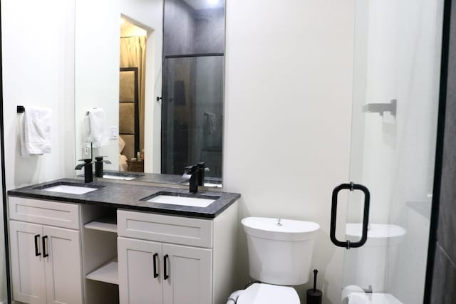 bathroom featuring vanity, toilet, and walk in shower