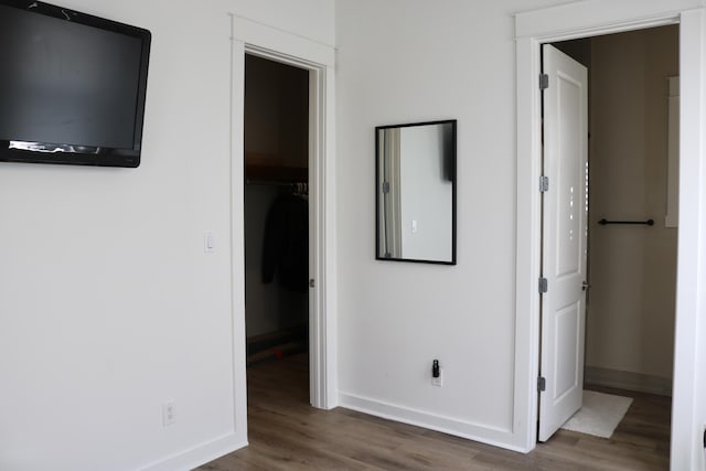 unfurnished bedroom featuring dark hardwood / wood-style floors and a spacious closet