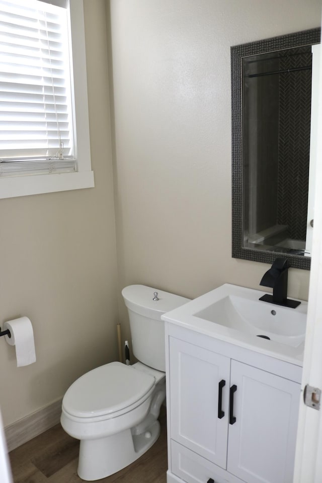 bathroom featuring vanity, toilet, and wood-type flooring