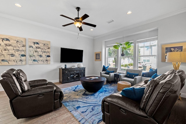 living room with light hardwood / wood-style floors, ceiling fan, and ornamental molding