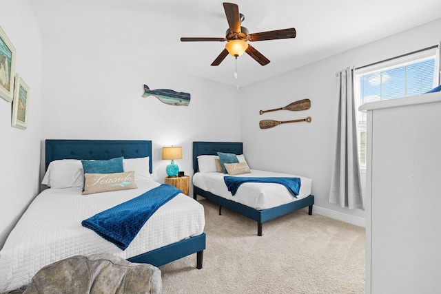 bedroom with ceiling fan and light carpet