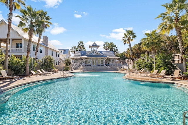 view of swimming pool featuring pool water feature and a patio