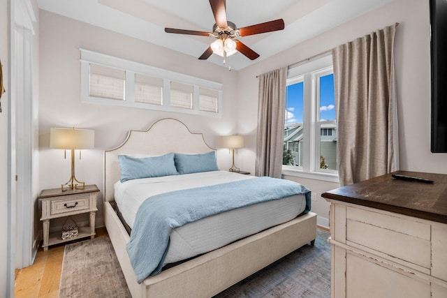 bedroom with wood-type flooring and ceiling fan