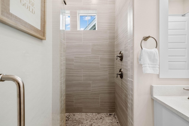 bathroom featuring vanity and tiled shower