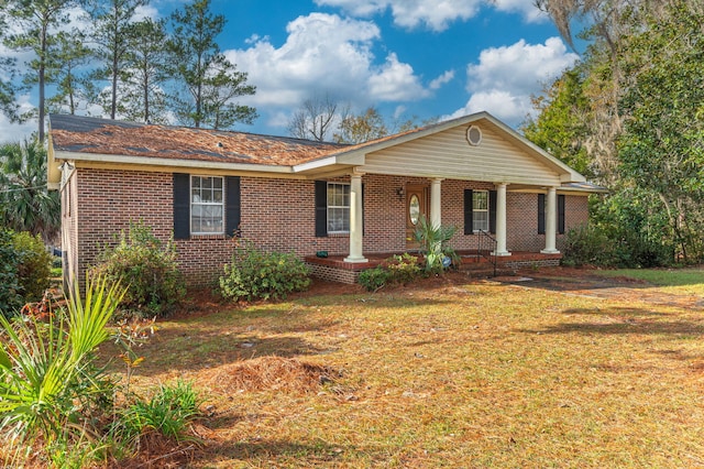 view of front of house with a porch and a front lawn