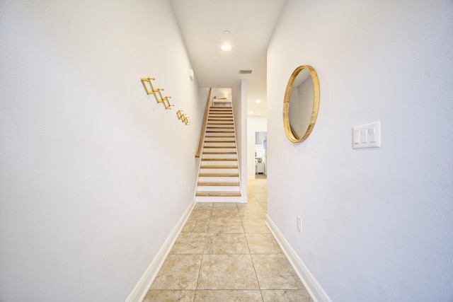 hallway featuring light tile patterned floors