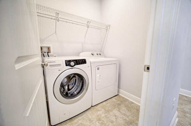 clothes washing area with separate washer and dryer