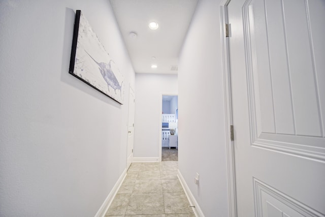 corridor featuring light tile patterned floors