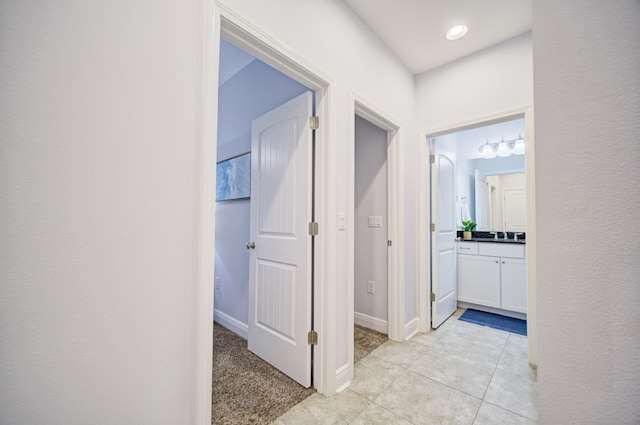 hall with light tile patterned floors