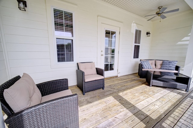 wooden terrace featuring ceiling fan and an outdoor hangout area