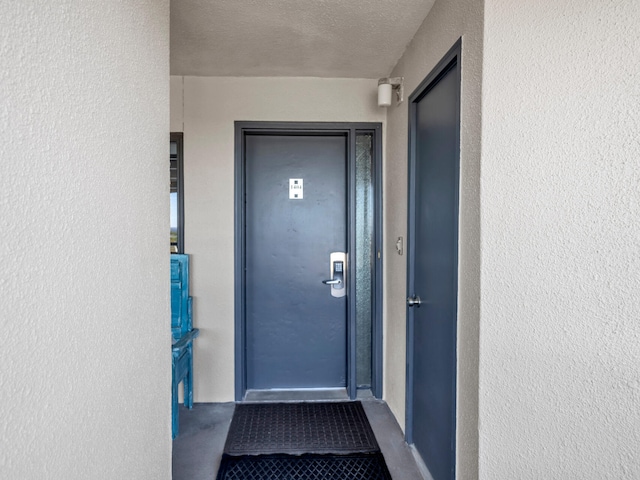 view of exterior entry with stucco siding