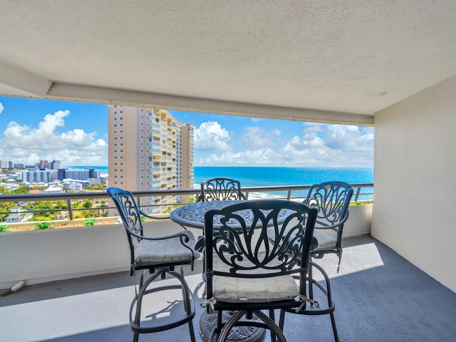 balcony with a water view and a city view