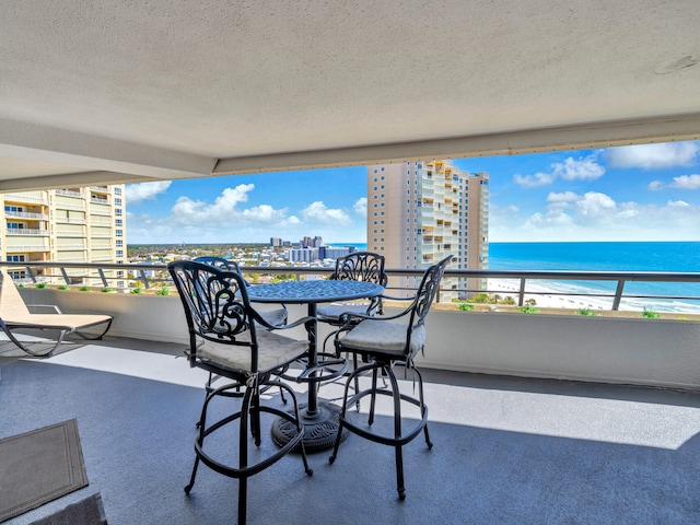 balcony with a view of city and a water view