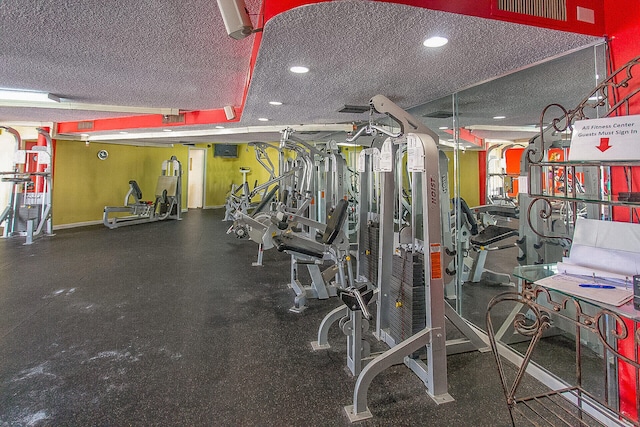 workout area featuring visible vents, a textured ceiling, and recessed lighting