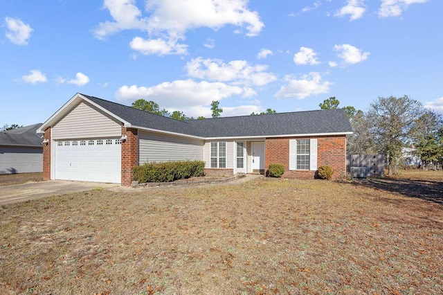 ranch-style home with a garage and a front yard