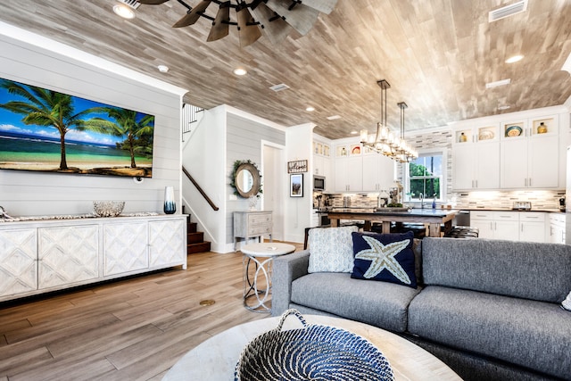 11 Wadleigh Way, Miramar Beach, FL 32550 - living area with wood ceiling, visible vents, light wood-style flooring, and stairs